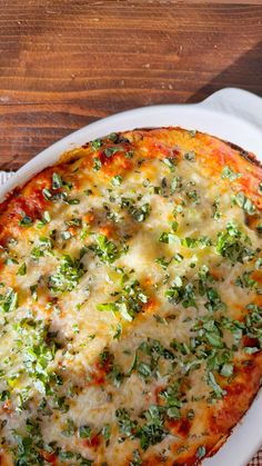 a casserole dish with cheese and broccoli in it on a white plate