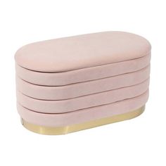 the pink velvet ottoman with gold trim is shown in front of a white background and it has