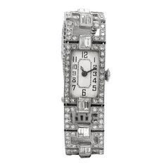 This timeless Antique art deco Ladies diamond watch, crafted in sensual 42.8 grams of platinum. This mesh link flexible watch was created in 1920's era.   Featuring 16 larger  bagguet cut Diamonds and 168 round faceted icy white Diamonds surrounding.The bezel and down through edge of the Platinum mesh bracelet   This mechanical vinding movement watch features a White dial wit black Arabic numerals.This watch secures with a insert clsp buckle.Measurement: 6.25 Inches x 14mmDiamonds: 2.90  carats Art Deco Platinum Evening Watches, Platinum Art Deco Evening Watches, Art Deco Evening Watch With Diamond Hour Markers, Antique Platinum Evening Watches, Art Deco Diamond Watch For Evening, Art Deco Rectangular Watch With Diamond Hour Markers, Art Deco Rectangular Watch With Diamond Markers, Art Deco Platinum Diamond Watch In White Gold, Art Deco Platinum Watch For Anniversary