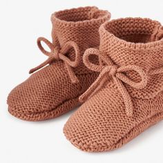 These comfortable hand-crocheted booties are the perfect, soft-sided shoe for every little one's tiny toes. The soft knitting feels dreamy on those sensitive baby feet. These adorable, cotton garter knit booties blend fashion and comfort for every little adventurer. 100% cotton Hand crocheted Fits 0-6 months Adjustable drawstring bow Damp wipe to clean Cozy Knitted Booties With Round Toe, Casual Hand Knitted Round Toe Booties, Cozy Soft Booties With Round Toe, Cozy Hand Knitted Round Toe Booties, Comfortable Winter Booties With Soft Sole, Crochet Booties With Round Toe For Winter, Cute Hand Knitted Round Toe Booties, Cute Knitted Round Toe Booties, Casual Crochet Booties With Round Toe