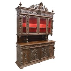 an ornate wooden cabinet with red glass doors