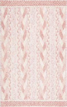 a pink and white rug with an intricate design