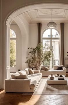 a living room filled with lots of white furniture