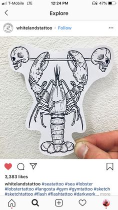 someone is holding up a sticker with two lobsters on it