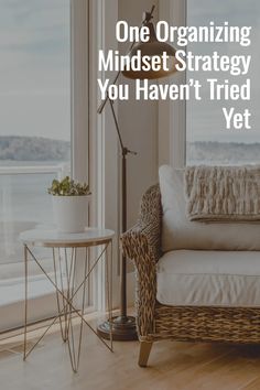 a couch sitting next to a window with the words, one organizing mindset strategy you haven't tried yet