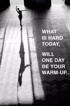 a person standing in the middle of a room with a shadow on the floor that says, what is hard today, will one day be your warm - up