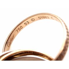 two gold wedding bands with engraved names and date on the side, set against a white background