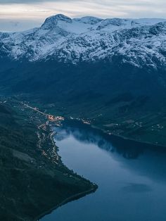 an aerial view of the mountains and water