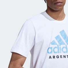 adidas 2022-23 Argentina Graphic Tee White Argentina through and through. This graphic t-shirt lets you rep your team wherever you go. Soft cotton will keep you comfortable, and the adidas Badge of Sport on the chest with the federation's crest leave no doubt about your allegiance. Our cotton products support more sustainable cotton farming. Regular fit Ribbed crewneck 100% cotton single jersey White Adidas T-shirt For Sports Events, Adidas Three Stripes T-shirt For Sports Events, Adidas Three Stripes T-shirt For Sports, Adidas T-shirt With Three Stripes For Sports Events, Adidas T-shirt With Three Stripes Branding, Adidas White T-shirt For Sports Season, Adidas White T-shirt For Sports, White Adidas T-shirt, White Adidas Logo Sports T-shirt