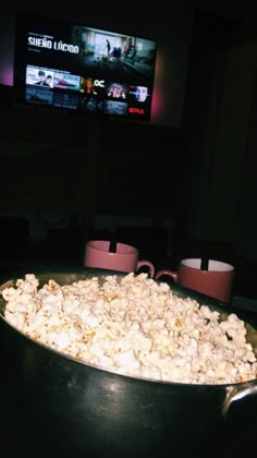 a pan filled with popcorn sitting on top of a table