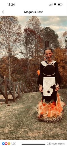 a woman dressed as a cow standing on top of a field