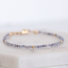 You will love this this dainty blue tanzanite bracelet! The vibrant tanzanite beads are  paired with subtle gold-filled accent beads, giving it just the right amount of shimmer. The adjustable clasp makes it super easy to get the perfect fit, whether you're wearing it solo or stacking it with your other favorites. This bracelet is the perfect mix of casual and chic, making it a go-to piece for any occasion. This bracelet is hand made and uses only natural products.  It is waterproof and will not Tanzanite Beads, Rustic Accessories, Tanzanite Bracelet, Tanzanite Gemstone, Blue Tanzanite, December Birthstone, Bijoux Diy, Natural Products, Stylish Jewelry