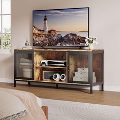 a flat screen tv sitting on top of a wooden cabinet