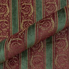 red and green striped fabric with gold swirls on the bottom, in an ornate pattern