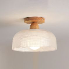 a wooden light fixture hanging from the ceiling