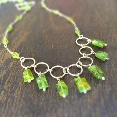 This peridot necklace is made of 5-7mm peridot nugget gemstones and peridot oval gemstones, sterling silver: chain, spring ring clasp and findings. This necklace measures 18 inches in length. All of our jewelry is unique and custom designed. Most of our jewelry can easily be resized. If there is a piece of jewelry that you are interested in, but would like some changes made, please do not hesitate to contact us. We appreciate your shopping with Jewelry by CARMAL and hope you will do so often! Pl Green Peridot Necklace For May Birthstone, Lime Green Peridot Necklace For May Birthstone, Green Peridot Gemstone Necklace, Oval Green Peridot Necklaces, Lime Green Peridot Jewelry For May Birthstone, Green Peridot Jewelry With Gemstone Beads, Green Peridot Gemstone Beads Jewelry, Handmade Green Peridot Necklaces, Peridot Gemstone Necklaces