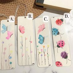 four bookmarks with ladybugs and flowers painted on them