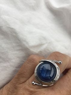 great color Deep blue Kyanite stone surrounded by a cool modern setting The setting is handcrafted in Sterling silver Size 7.5 Can be sized All rings are shipped in a nice gift box. Check out our over a THOUSAND great reviews Engraving is $4 per letter and is not always perfect depending on the piece. It can take a few days if the jeweler is busy. This is payable to Paypal Judithsltd@gmail.com Sapphire Moonstone Ring In Sterling Silver As Gift, Modern Cabochon Sapphire Ring For Gift, Blue Polished Open Ring Jewelry, Blue Polished Finish Open Ring Jewelry, Blue Open Ring Jewelry With Polished Finish, Handmade Blue Sapphire Open Ring, Modern Handmade Sterling Silver Moonstone Ring, Handmade Modern Moonstone Ring In Sterling Silver, Handmade Adjustable Blue Sapphire Ring