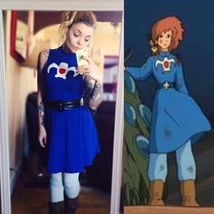 a woman in a blue dress and boots standing next to an image of a cartoon character