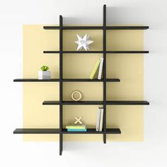 a book shelf with books and other items on it, along with an ornament