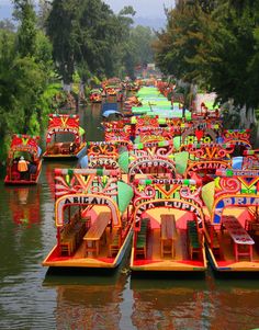 many colorful boats are lined up on the water