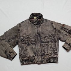 Super Rare Vintage 80s New Wave Todays News Black Acid Wash Denim Puffer Bomber Jacket. - Super Rare And Hard To Find - Black And Tan Acid Wash Denim - Full-Zip Front With Hem And Collar Snap Buttons - Thick Filling/ Insulated - Bomber Jacket Style - Wide Tapered Sleeves With Button Cuffs - Multi-Pocket- Zipper Arm Pocket, Five Slide Pockets (Includes Pen Pockets), Two Large Flap Pockets With Snap Button Closures (One Snap Is Broken) - High Collar - Fitted Elastic Hem - New Wave Cotton Lining, N 80s New Wave, Neon Printing, Acid Wash Denim, Vintage Jacket, Acid Wash, New Wave, High Collar, Black And Tan, Vintage Men