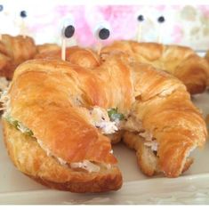 some croissants with googly eyes and toothpicks sticking out of them