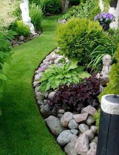 a garden with rocks and plants in it