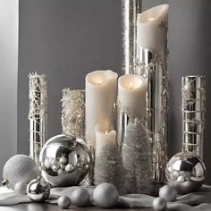 silver christmas decorations with candles and ornaments