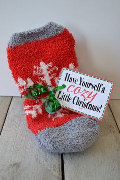 there is a christmas sock with a sign on it that says have yourself a cozy little christmas