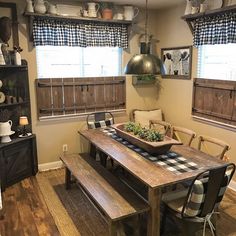 a dining room table with two benches in front of it