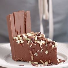 a piece of chocolate cake sitting on top of a white plate