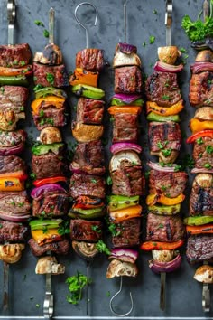 several skewers filled with different types of meat and veggies on them