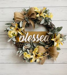 a wreath with the word dieselr on it and yellow flowers in front of white wood planks