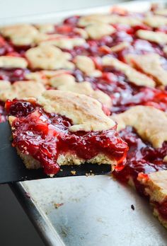 a close up of a pie on a pan with a spatula in it's hand