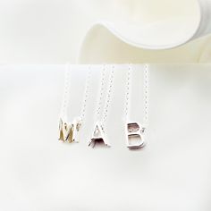 Elevate your everyday style with our Personalized Tiny Monogram Necklace! This initial charm necklace is the perfect way to show off your unique style and personality. Whether you choose your own initial or that of a loved one, this necklace is a beautiful way to add a personal touch to any outfit. Plus, it makes a wonderful gift for women who love simple, elegant jewelry. Please choose your letter at checkout. This necklace can be made of  one, two or three letters of your choice and one or two Classic Sterling Silver Initial Necklace For Personalized Gift, Silver Initials Necklace For Everyday, Everyday Sterling Silver Initials Charm Necklace, Everyday Silver Name Necklace With Initials, Classic Sterling Silver Charm Necklaces With Initials, Everyday Silver Necklaces With Initials, Everyday Silver Necklace With Custom Name, Minimalist Sterling Silver Name Necklace For Everyday, Classic Sterling Silver Initial Necklace For Mother's Day