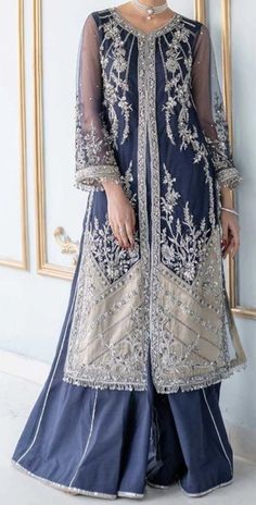 Perfect for special occasions and wedding gatherings, our statement blue front open jacket features silver appliqué on a navy tulle front. It is labor of extensive craftsmanship on a rather contemporary silhouette, making it an effortless style to pull off. Pieces Shirt Sharara & Undershirt Dupatta Elegant Royal Blue Set With Resham Embroidery, Elegant Royal Blue Sets For Reception, Elegant Royal Blue Reception Sets, Elegant Royal Blue Set With Dupatta, Blue Organza Sets With Long Sleeves, Blue Organza Long Sleeve Sets, Elegant Blue Sets For Reception, Elegant Blue Sets With Sheer Dupatta, Blue Pakistani Dress