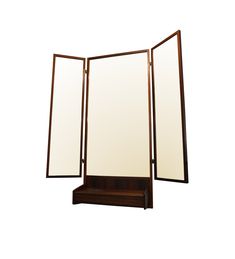 an open room divider sitting on top of a wooden shelf next to a mirror