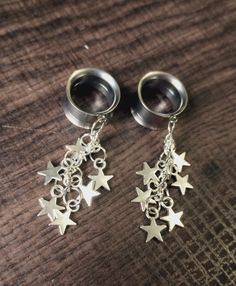 Reach for the stars with this unique pair of silver plated dangles on stainless steel tunnel screw backs.  Lightweight and comfortable to wear.  Approx. 2 inches long.  Perfect for a casual day. All earrings are made to order and sold in pairs.   No returns or exchanges for hygienic reasons. Should you have any questions, feel free to contact me before purchasing. Nickel-free Silver Dangle Belly Rings, Silver Dangle Belly Rings Nickel Free, Nickel Free Silver Star-shaped Piercing, Nickel-free Star-shaped Silver Piercings, Nickel-free Silver Star Piercings, Silver Hypoallergenic Dangle Belly Rings, Silver Dangle Belly Rings In Stainless Steel, Hypoallergenic Silver Dangle Belly Rings, Nickel Free Silver Dangle Piercings