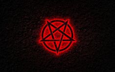 a red pentagramil in the middle of a black background with an orange light