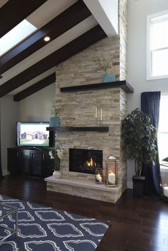 a living room with a large stone fireplace