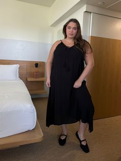 The Plus Size Tassel Tie Strap Midi Dress is a flowy midi dress that comes in taupe and black. This comfortable midi dress's lightweight fabric and simple tassel make this plus size midi dress ideal for vacations and brunches, The midi dress also comes with adjustable straps in the back! We recommend pairing this with any sandal or wedge that matches the color of the dress! 100% Rayon. Imported. Hand wash cold. Model pictured is wearing a 3XL. Beach Midi Dress With Tassels, Casual Maxi Dress With Tassel Ties, Black Rayon Midi Dress For Vacation, Vacation Midi Dress With Tassels, Black Rayon Midi Dress For Beach, Plus Size Black Midi Dress, Casual Black Dress With Tassels, Plus Size Midi Lbd, Black Feminine V-neck Midi Dress