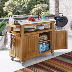 a kitchen island cart with food and drinks on it