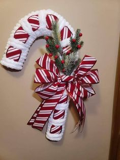 a candy cane wreath is hanging on the wall