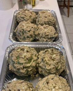 two trays filled with muffins sitting on top of a counter next to each other