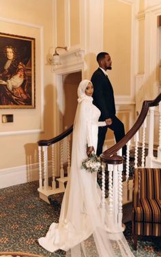 a bride and groom walking down the stairs at their wedding ceremony in an elegant hotel