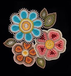 beaded flowers are shown on a black background