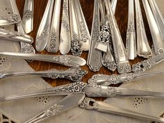 an assortment of silverware sitting on top of a table