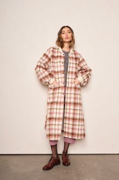 The Cameron coat adds a modern, feminine twist on the elemental bomber. Outfitted in a classic blush Plaid wool, this silhouette features exaggerated bishop sleeves, metal snap buttons, front patch pockets and classic rib trim. The perfect long coat to compliment your autumn ensemble. Our Model Kristi is 5’8 and wearing a XS. She normally wears XS, 26, or 0. Pink Plaid Coat, Plaid Coat Pink, Elegant Plaid Single-breasted Outerwear, Cozy Plaid Long Sleeve Outerwear, Oversized Single-breasted Plaid Outerwear, Wool Plaid, Denim Jumpsuit, Winter Sale, Long Coat