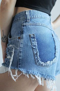 MUSTANG denim shorts, Vintage high waist with frayed legs and cut back pocket in Size W33 33 *High waist *Medium blue denim *Handmade holes and frayed legs *One of a kind item *100% Cotton denim - they do not stretch Size: Large / W33 (from tag) Waist: 32 inches / 81 cm Hips: 43 inches / 109 cm Rise: 13 3/4 inches / 35 cm Inseam: 2 inches / 5,5 cm Take a look at other denim shorts from my shop: https://www.etsy.com/shop/sisudenimstore?section_id=21382979 Sisu Denim is a part of Sisu Vintage Stor Distressed Cotton Cutoff Shorts, High-waisted Jean Shorts With Frayed Hem, Faded Cutoff Jean Shorts With Frayed Hem, Ripped Medium Wash Shorts, Denim Blue Jean Shorts With Frayed Hem, Faded Mid-rise Jean Shorts With Frayed Hem, Distressed Mid-rise Denim Blue Shorts, Distressed Denim Blue Mid-rise Shorts, Dark Wash Short Leg Jeans With Frayed Hem